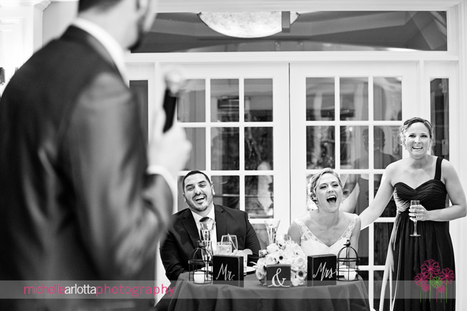 bride and groom laughing during best man toast