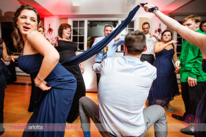 guest using bridesmaid dress for limbo at rock island lake club wedding