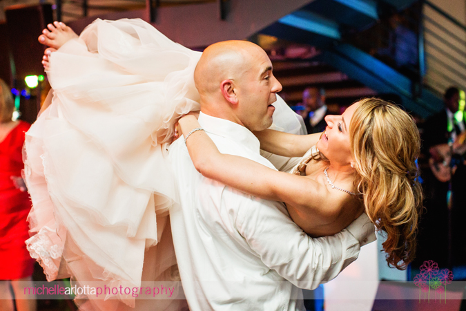 bride picked up in arms by guest on dance floor