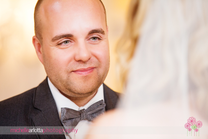 groom looking into bride's eyes during ceremony