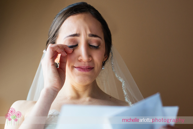 bride crying while reading card from groom