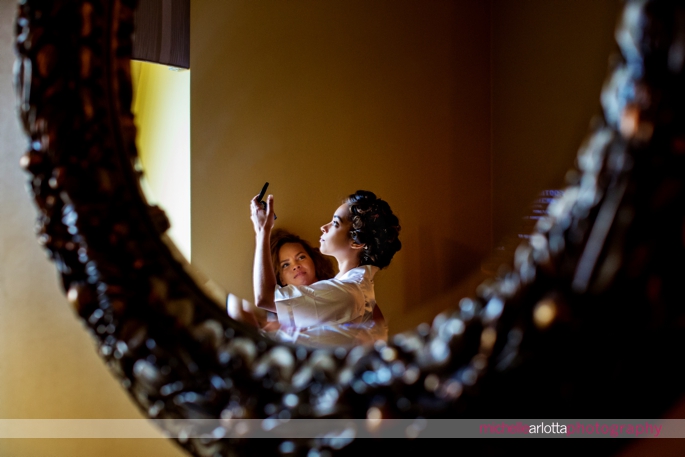 bride checks herself in mirror at Nassau inn wedding with michelle Arlotta photography