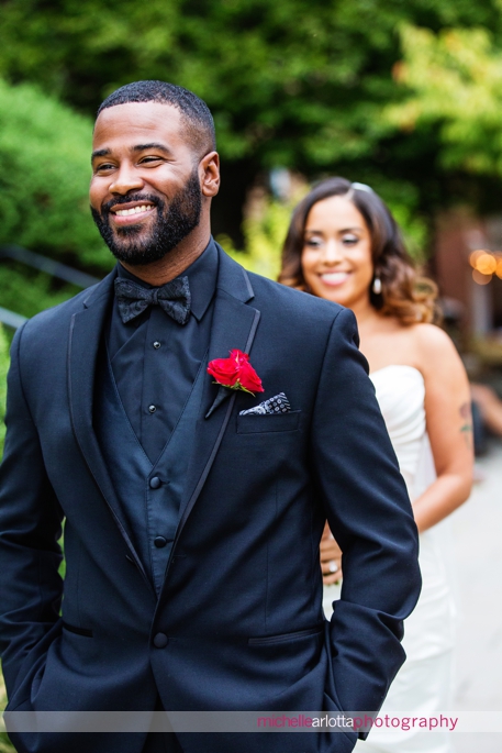 groom in black shirt and black jacket smiles just before first look at princeton wedding
