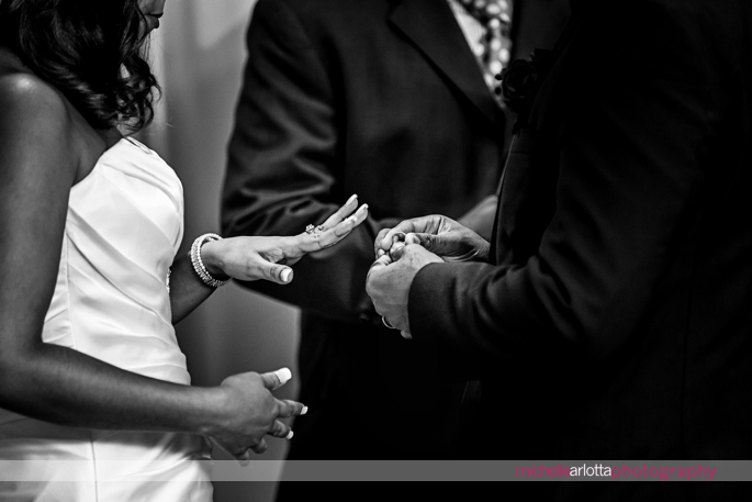 bride waits for her ring to be put on during Nassau inn indoor wedding ceremony