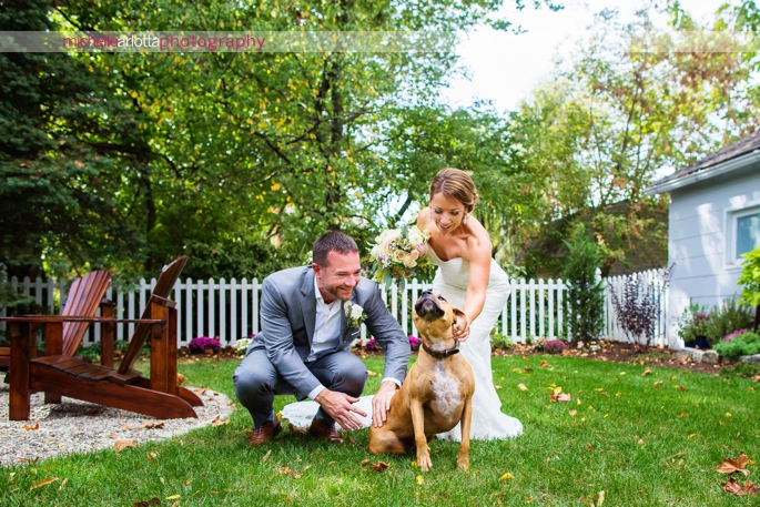 bride and groom pet their dog during portraits