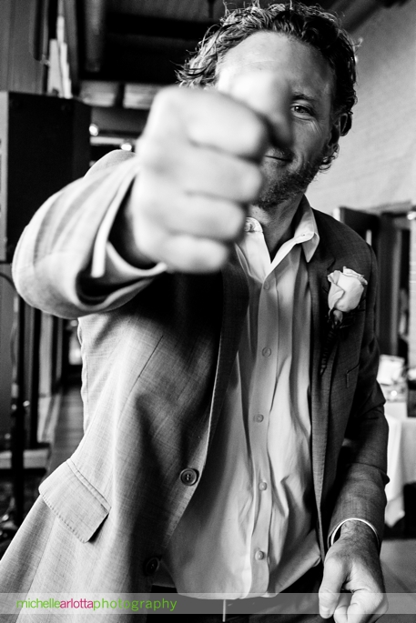 groomsmen fist bumps New Jersey wedding photographer michelle arlotta's camera