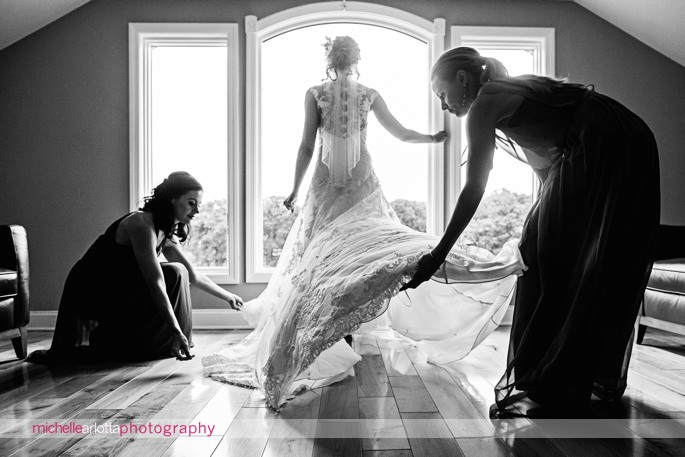 bridesmaids adjust wedding dress in rock island lake club bridal suite