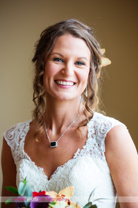 portrait of bride with flower in her hair, emerald neckless at the rock island lake club