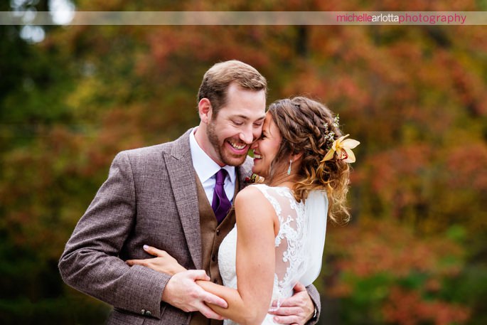 bride and groom portraits in the woods with vibrant fall foilage at rock island lake club wedding photographed by New Jersey wedding photographer michelle arlotta