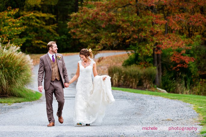 bride and groom walking together at rock island lake club fall wedding photographed by New Jersey wedding photographer michelle arlotta