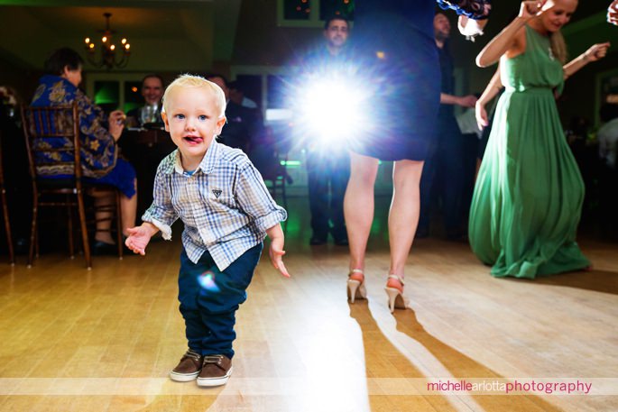 little kid having fun on dance floor at rock island lake club wedding reception
