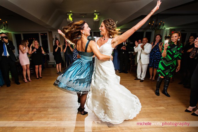 wedding guests dance to Ukrainian music during rock island lake club wedding reception