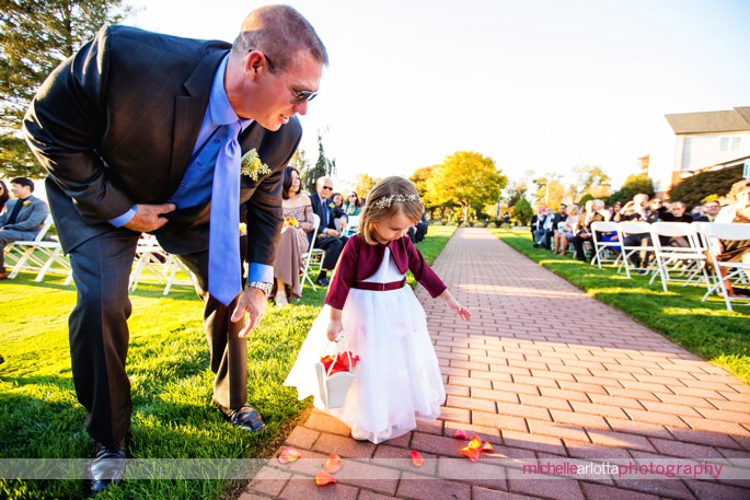 flower girl gets help spreading flowers at nj outdoor wedding ceremony
