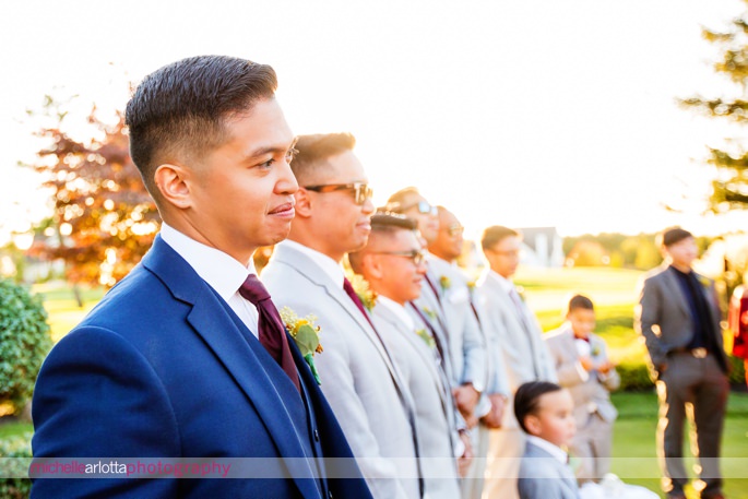 groom watches bride walk down aisle at outdoor wedding ceremony at battleground country club