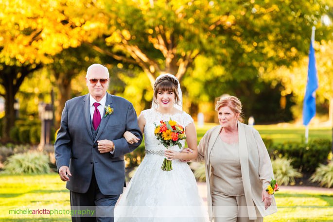 bride walks down the aisle in 3graces bridal wedding dress at battleground country club
