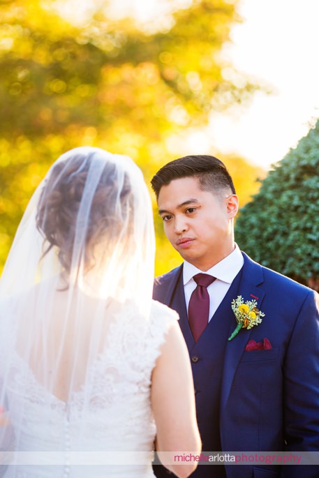 groom in blue suit and maroon tie