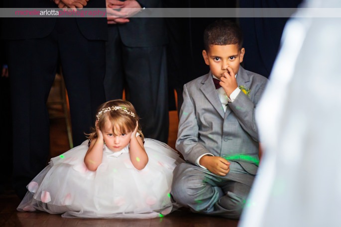 flower girls puts hands over ears while ring bearer picks nose during bride and groom's first dance at New Jersey wedding venue