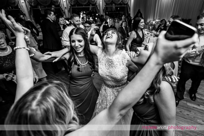 bride and bridesmaids dance together during nj wedding reception