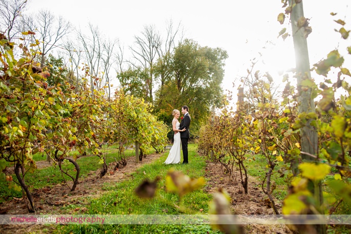 elegant bride in nicole miller NYC wedding gown and groom in tuxedo at brotherhood winery wedding in washingontonville, ny by michelle Arlotta photography