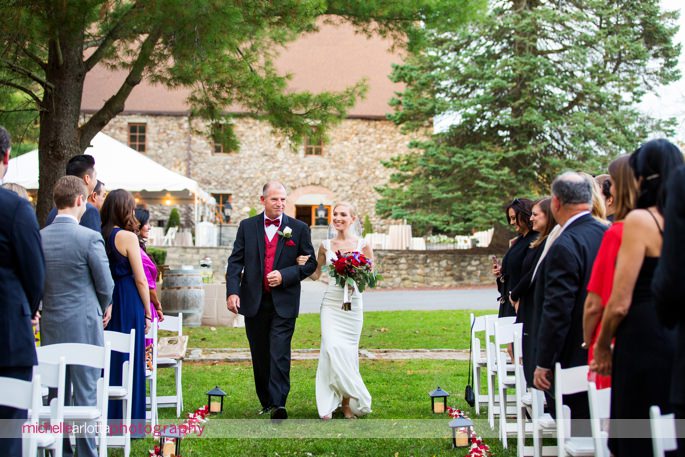 bride in nicole miller gown walks down aisle with father at Hudson valley wedding