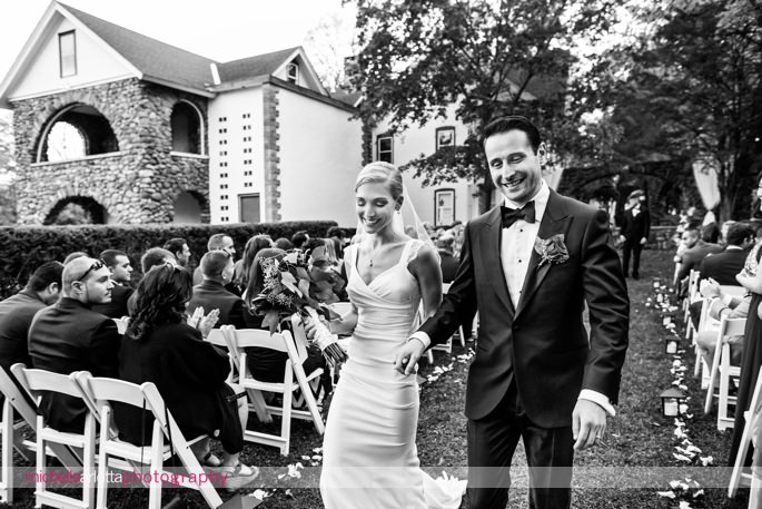 bride and groom exit their outdoor fall wedding ceremony at brotherhood winery photographed by Hudson valley wedding by michelle arlotta