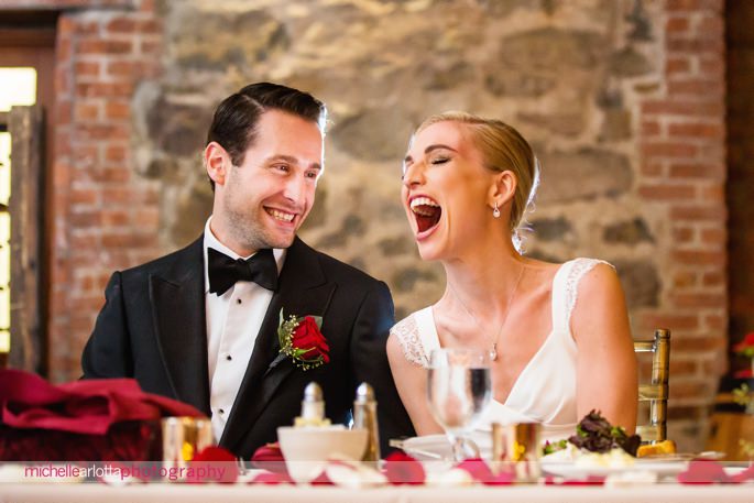 bride and groom laugh during wedding speeches at brotherhood winery New York wedding