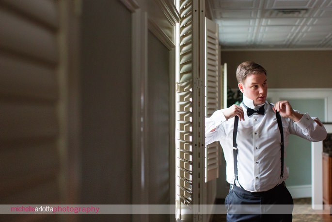 groom getting ready with bowtie for New Jersey wedding
