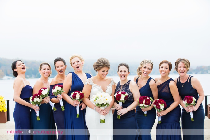 bride and bridesmaids in navy blue laughing