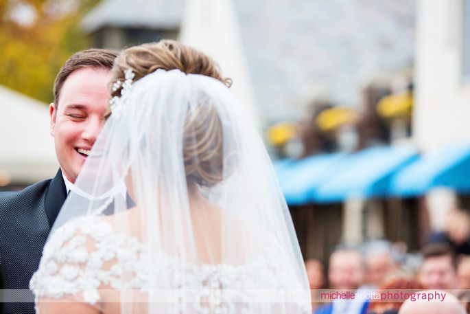 groom laughs during outdoor fall wedding ceremony