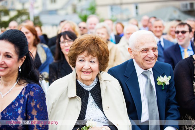 bride's grandparents smile and laugh during nj wedding ceremony