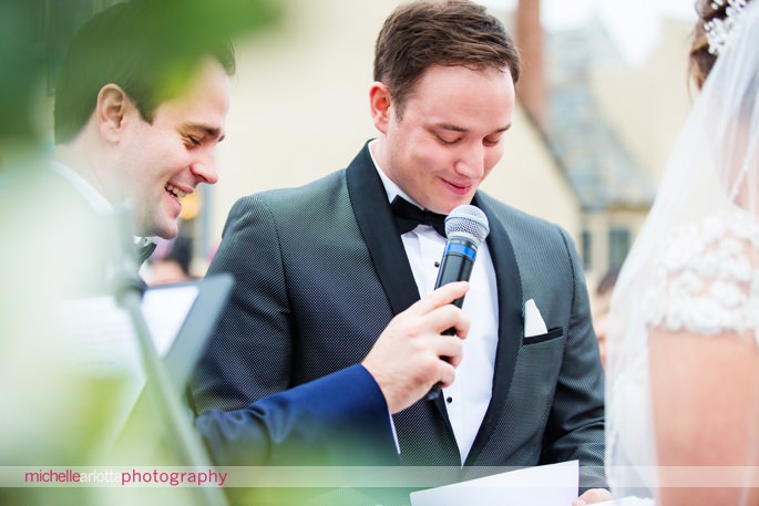 best man holds microphone for groom during wedding vows in New Jersey