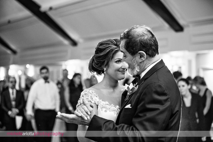 bride looks up at her dad and smiles during first dance at Sussex county, New Jersey wedding reception