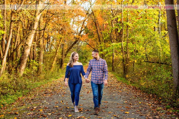 bear brook valley couple holding hands and walking during fall engagement session in Frenchtown New Jersey michelle Arlotta photography