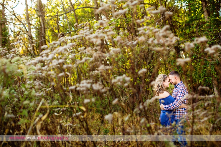 couple laughs and embraces among fields in hunterdon county New Jersey michelle Arlotta photography