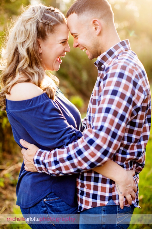 bear brook valley wedding couple laughing during beautiful fall engagement session during golden hour in new jersey