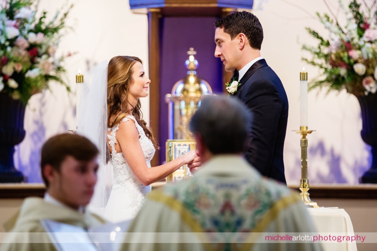bride and groom say vows during nj wedding ceremony at st. Elizabeth Ann seton three bridges church