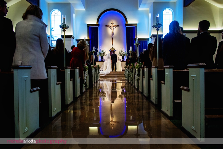 wide angle shot of bride and grom at altar of New Jersey st Elizabeth Ann seton three bridges church