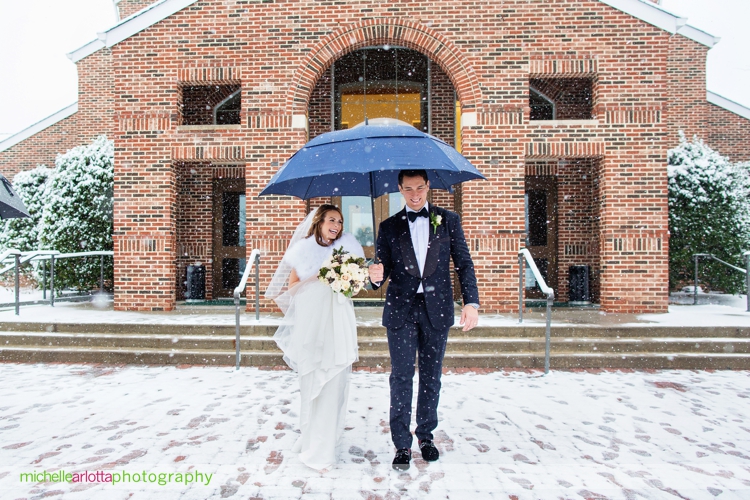 bride and groom exit nj church in snowstorm
