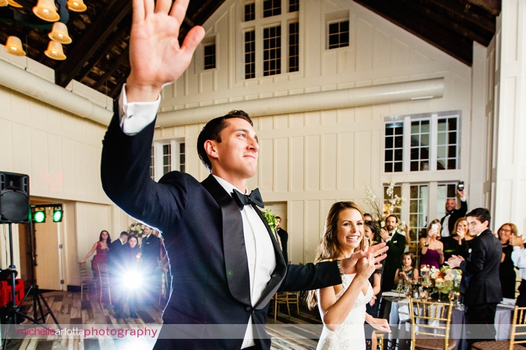 bride and groom enter their coach house ballroom wedding reception
