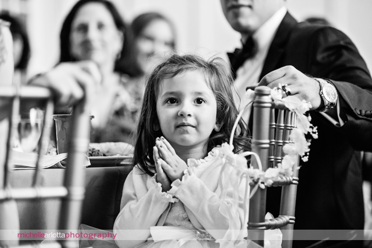 flower girl smiles and claps hands during wedding toast at Ryland inn