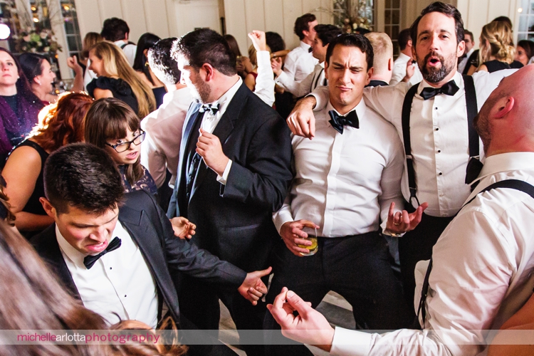 groom and wedding guests doing air guitar to Craig Scott entertainment music at Ryland inn wedding reception