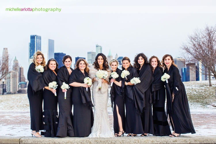 bridesmaids in black dresses during winter wedding in liberty state park