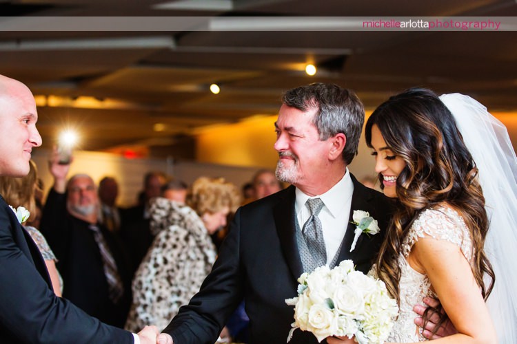 father of the bride shakes groom's hand at indoor wedding ceremony at maritime Parc