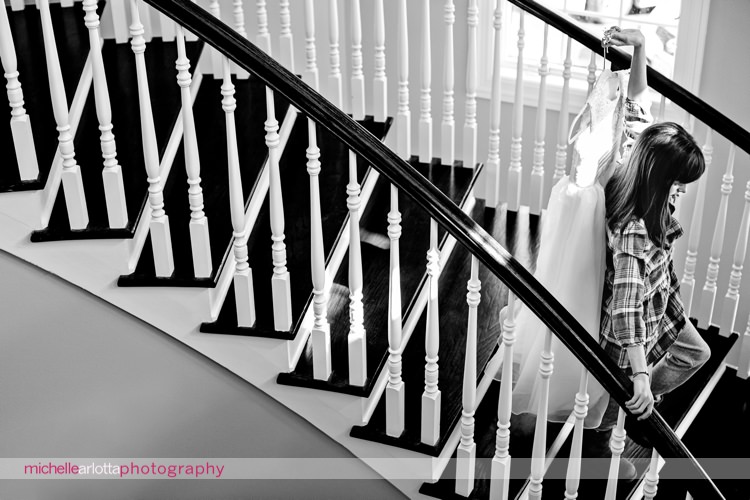 flower girl walks down the steps with her dress at the rock island lake club in New Jersey