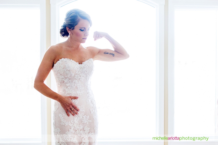 bride with 'live easy' tattoo flexes in her wedding gown