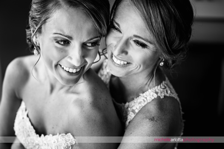 two brides laughing together inside at rock island lake club in New Jersey