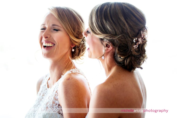 two brides laughing during rock island lake club winter wedding with New Jersey wedding photographer Michelle arlotta
