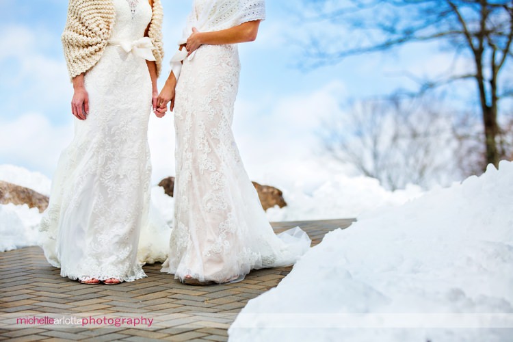 brides with white shawls outside at rock island lake club winter wedding