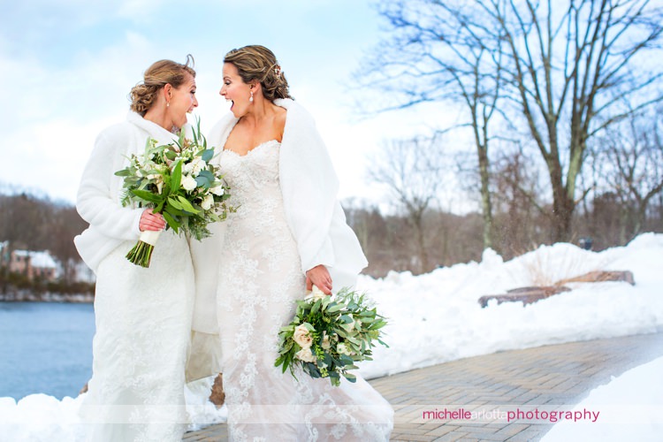 brides have matching expression as wind gusts come by at New Jersey's rock island lake club same sex wedding