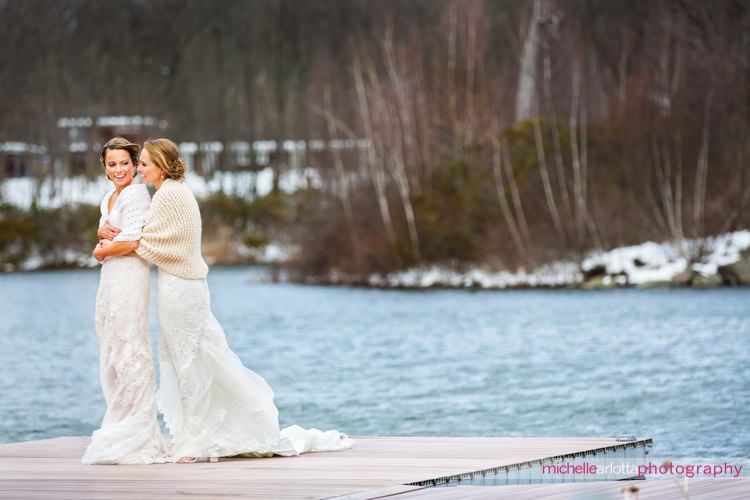 brides on dock at rock island lake club winter wedding